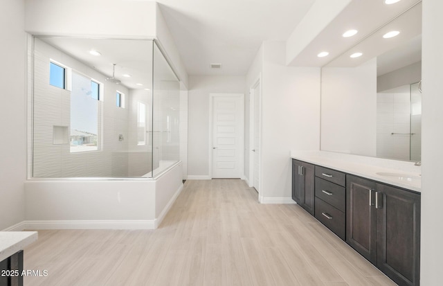18716 N 269th Ln, Buckeye, AZ 85396 - full bathroom featuring baseboards, vanity, wood finished floors, a walk in shower, and recessed lighting