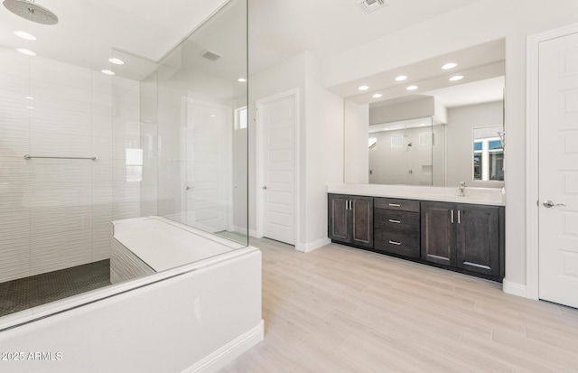 18716 N 269th Ln, Buckeye, AZ 85396 - bathroom with a walk in shower, vanity, wood finished floors, recessed lighting, and baseboards