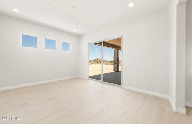 18716 N 269th Ln, Buckeye, AZ 85396 - unfurnished room with light wood-type flooring, baseboards, and recessed lighting