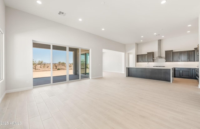 18716 N 269th Ln, Buckeye, AZ 85396 - unfurnished living room with baseboards, recessed lighting, and light wood-style floors