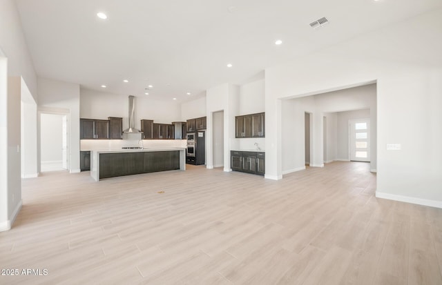 18716 N 269th Ln, Buckeye, AZ 85396 - unfurnished living room with a sink, baseboards, light wood finished floors, and recessed lighting