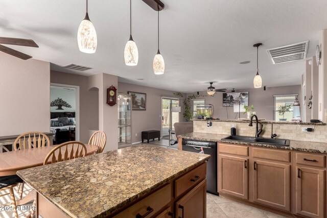 kitchen with black dishwasher, visible vents, decorative backsplash, dark stone counters, and a sink