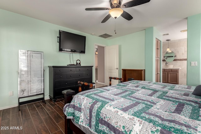 bedroom with ensuite bath, visible vents, a ceiling fan, and wood finish floors