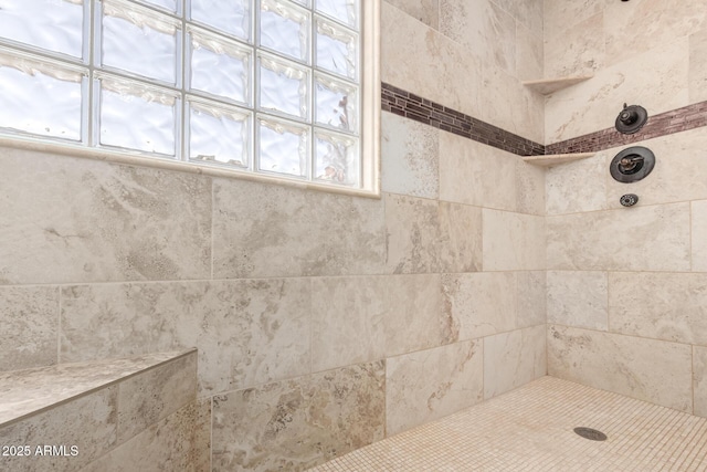 bathroom featuring tiled shower