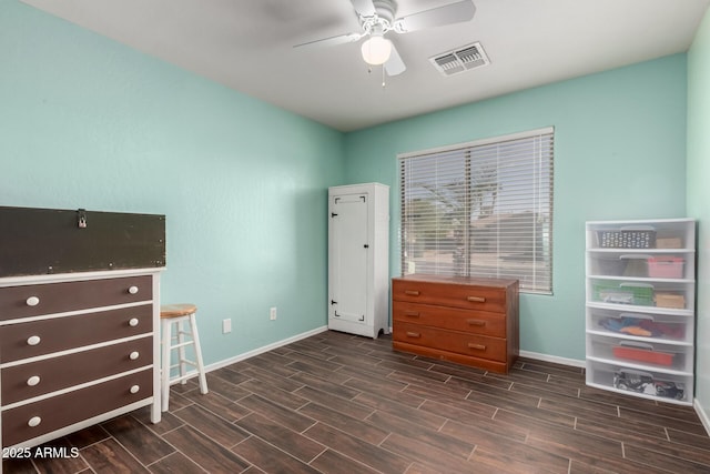 unfurnished bedroom with baseboards, visible vents, a ceiling fan, and wood finish floors