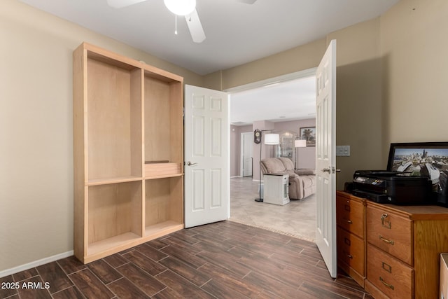 unfurnished bedroom with wood tiled floor, ceiling fan, and baseboards