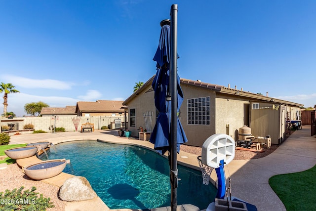 view of swimming pool featuring a patio area, a fenced backyard, and a fenced in pool