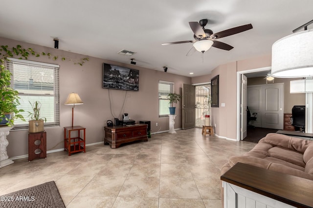 living room with baseboards, visible vents, a ceiling fan, and light tile patterned flooring