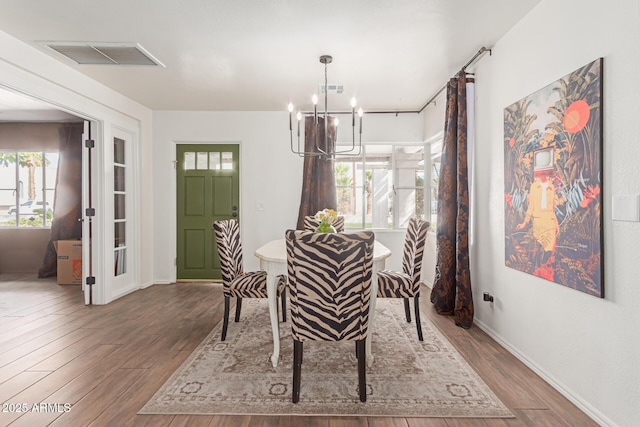 430 N Vineyard, Mesa, AZ 85201 - dining area featuring a wealth of natural light, visible vents, wood finished floors, and a notable chandelier