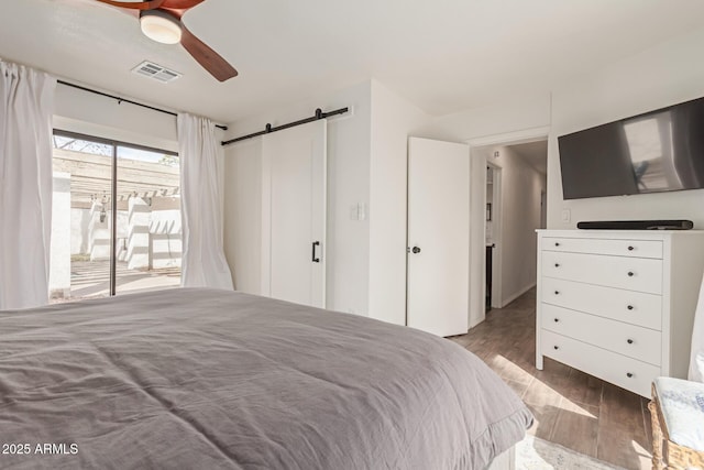 430 N Vineyard, Mesa, AZ 85201 - bedroom with visible vents, wood finished floors, access to outside, a barn door, and a ceiling fan