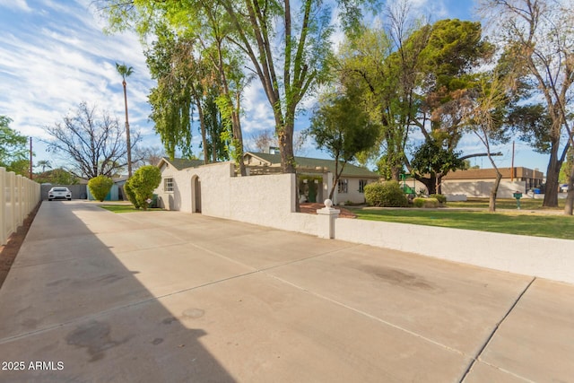 430 N Vineyard, Mesa, AZ 85201 - view of home's exterior featuring fence, stucco siding, and driveway