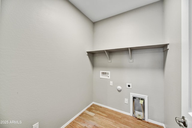 clothes washing area featuring washer hookup, hookup for a gas dryer, light wood-style floors, hookup for an electric dryer, and laundry area