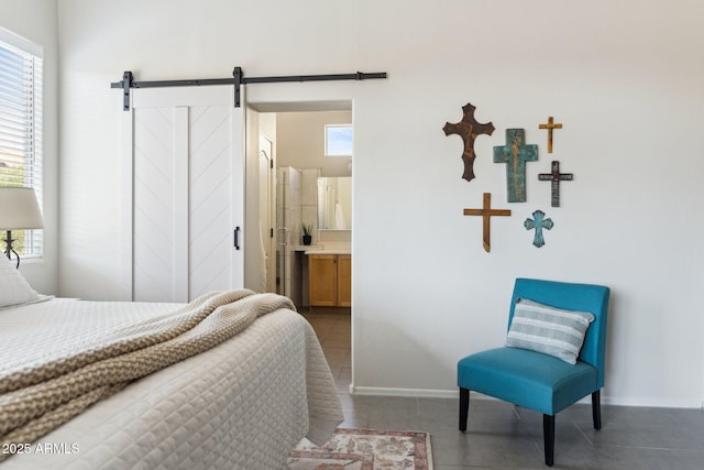 tiled bedroom with multiple windows, baseboards, and a barn door