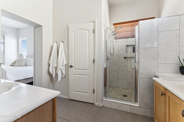 bathroom with a stall shower, vanity, and ensuite bathroom