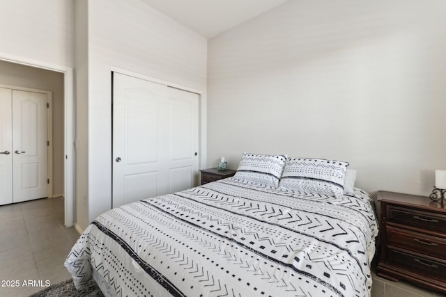 bedroom with light tile patterned floors and a closet