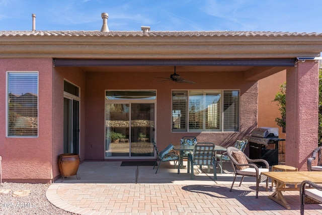 view of patio / terrace featuring area for grilling and a ceiling fan