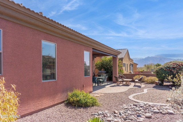 view of yard featuring a mountain view and a patio