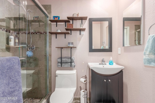 bathroom featuring walk in shower, vanity, and toilet