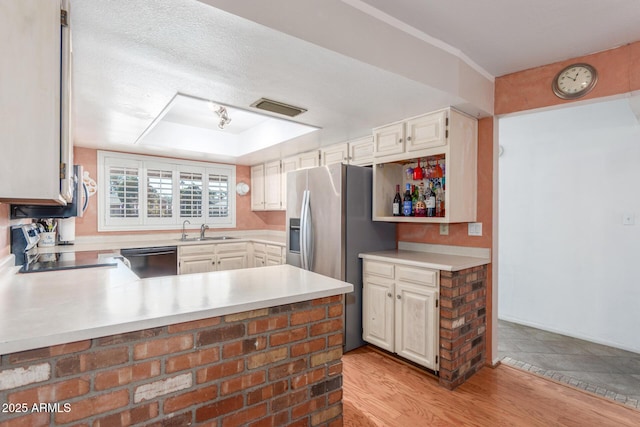 kitchen featuring dishwasher, sink, kitchen peninsula, stove, and light hardwood / wood-style floors