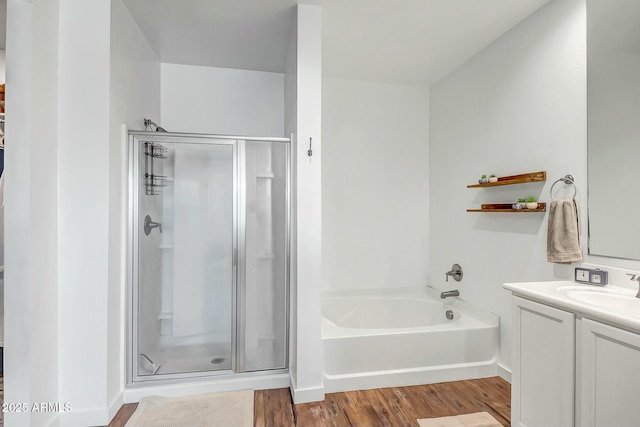 bathroom featuring vanity, shower with separate bathtub, and hardwood / wood-style floors