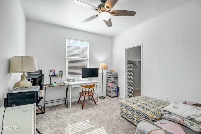 office area featuring light carpet and ceiling fan