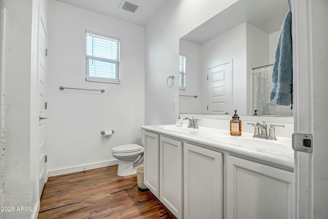 bathroom with vanity, hardwood / wood-style floors, toilet, and a bidet