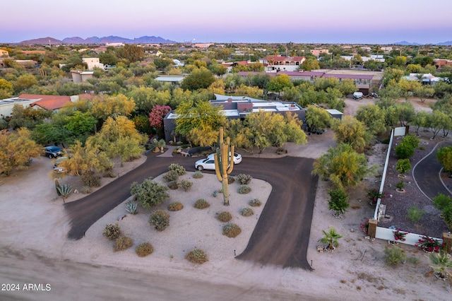 aerial view at dusk featuring a mountain view