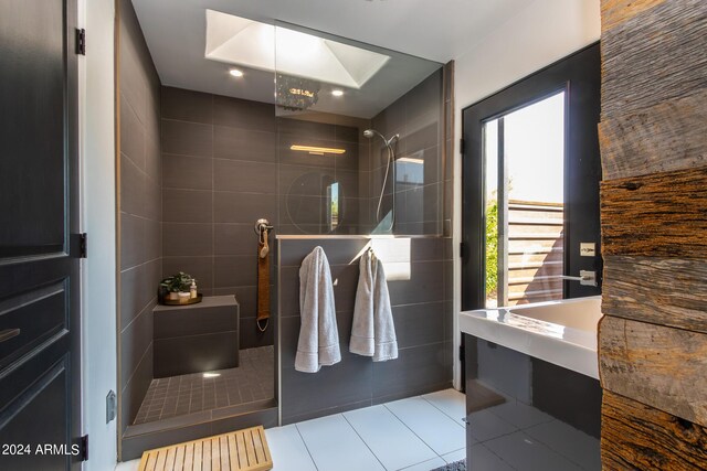 bathroom featuring tile walls, tile patterned floors, and a shower