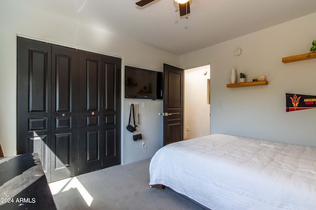 carpeted bedroom featuring ceiling fan and a closet