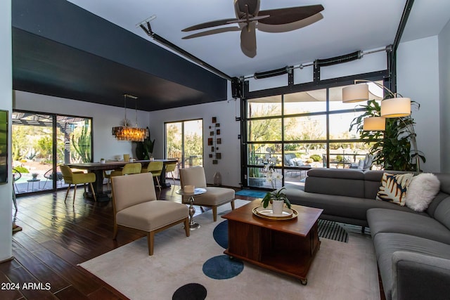 living room with hardwood / wood-style flooring and ceiling fan