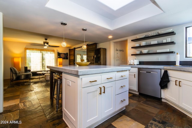 kitchen featuring a kitchen island, dishwasher, hanging light fixtures, and white cabinets