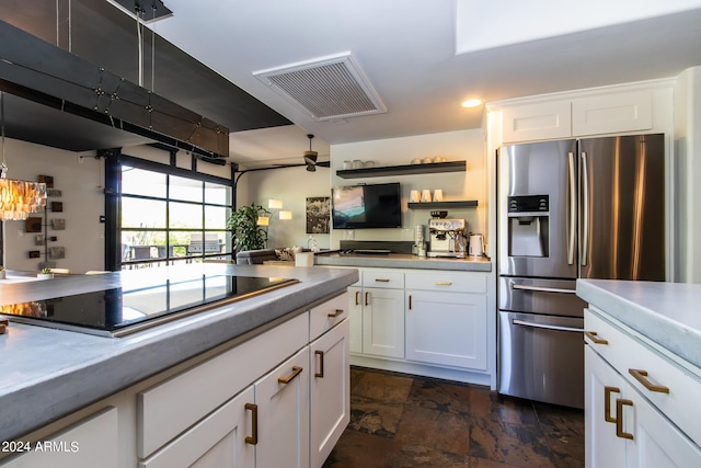 kitchen with white cabinetry, stainless steel fridge, black electric cooktop, and ceiling fan