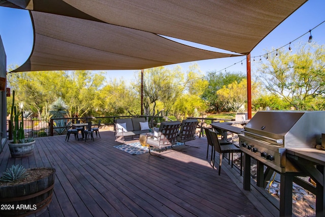 deck with an outdoor hangout area and grilling area