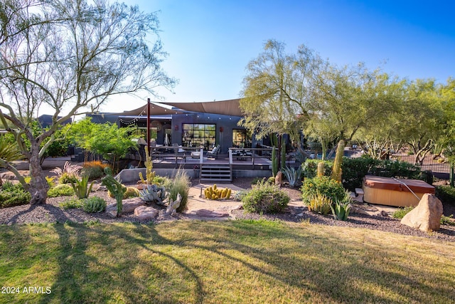 view of yard with a hot tub and a deck