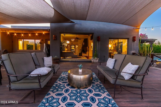 deck at dusk with an outdoor living space