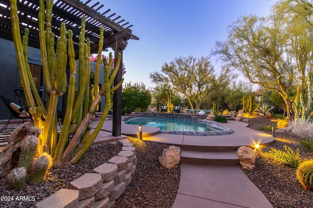 pool at dusk featuring a pergola