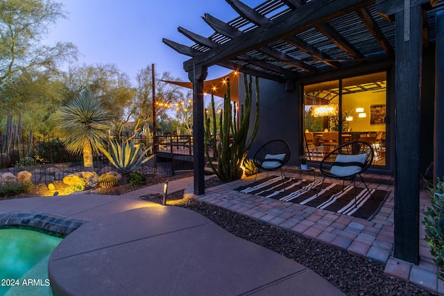 patio terrace at dusk featuring a pergola