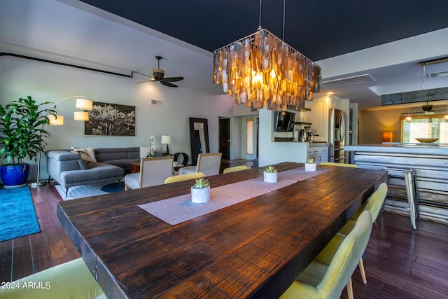 dining space with dark wood-type flooring and ceiling fan with notable chandelier