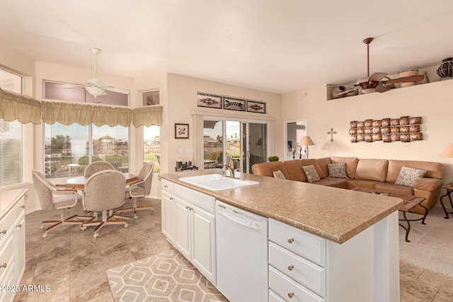 kitchen with white cabinets, ceiling fan, a kitchen island with sink, sink, and dishwasher