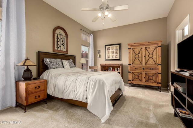 bedroom with light carpet, vaulted ceiling, and ceiling fan