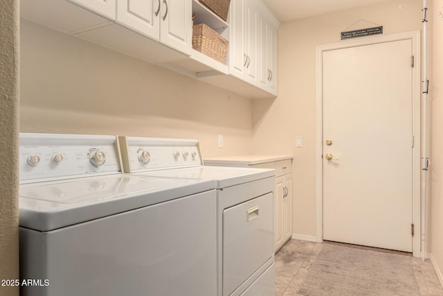 laundry area featuring cabinets and separate washer and dryer