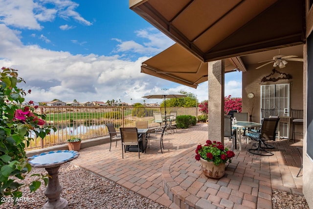 view of patio / terrace featuring ceiling fan and a water view