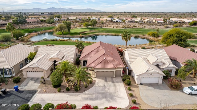 birds eye view of property with a water and mountain view