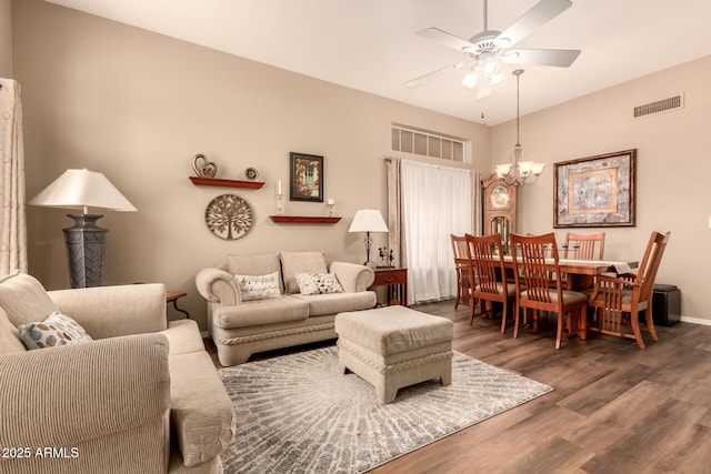 living room featuring wood-type flooring and ceiling fan with notable chandelier