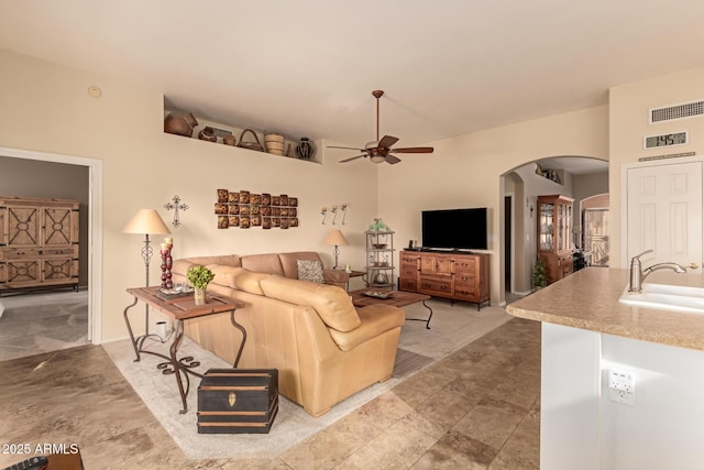 living room with ceiling fan and sink