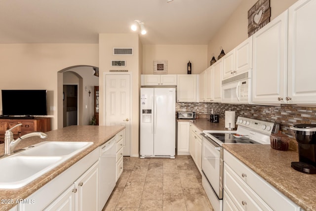 kitchen with decorative backsplash, white appliances, white cabinetry, and sink