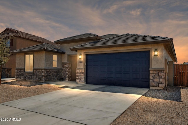 1135 E Barrus Dr, Casa Grande, AZ 85122 - prairie-style house featuring stucco siding, stone siding, a tiled roof, driveway, and a garage