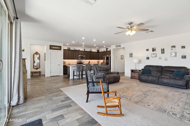 1135 E Barrus Dr, Casa Grande, AZ 85122 - living room featuring wood finish floors, recessed lighting, ceiling fan, and visible vents