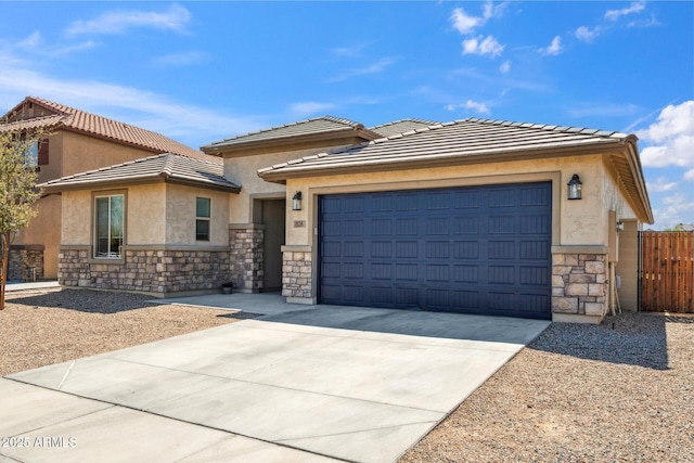 1135 E Barrus Dr, Casa Grande, AZ 85122 - prairie-style house featuring stone siding, driveway, an attached garage, and stucco siding