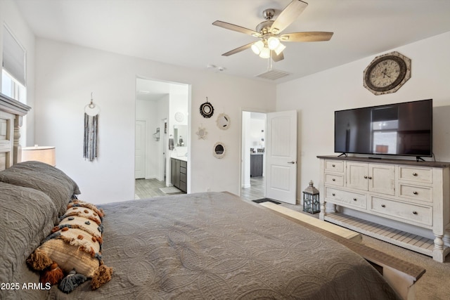 1135 E Barrus Dr, Casa Grande, AZ 85122 - bedroom featuring ensuite bathroom, visible vents, a ceiling fan, and light carpet